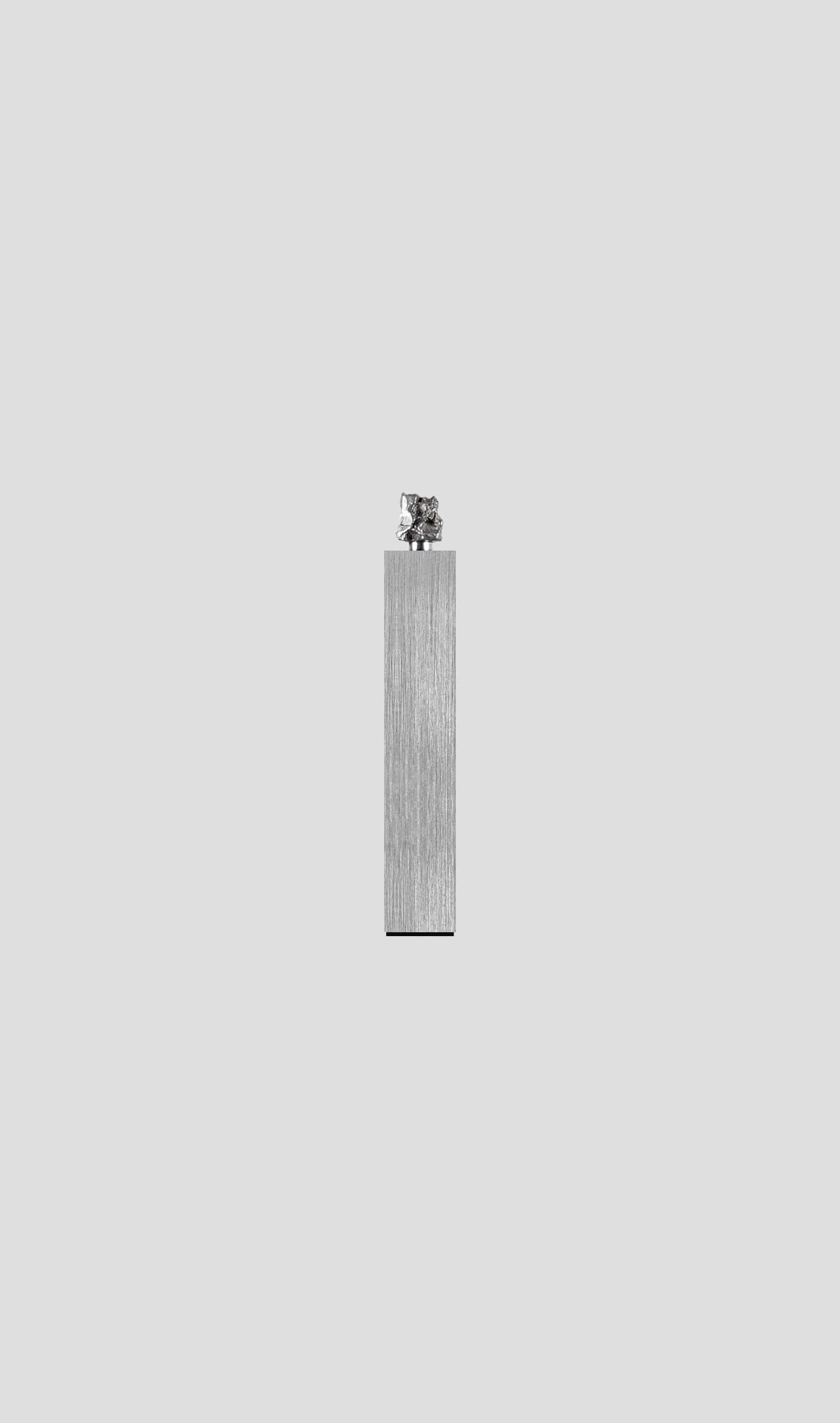 Campo Del Cielo meteorite fragment on brushed aluminum base, showcasing timeless cosmic elegance.