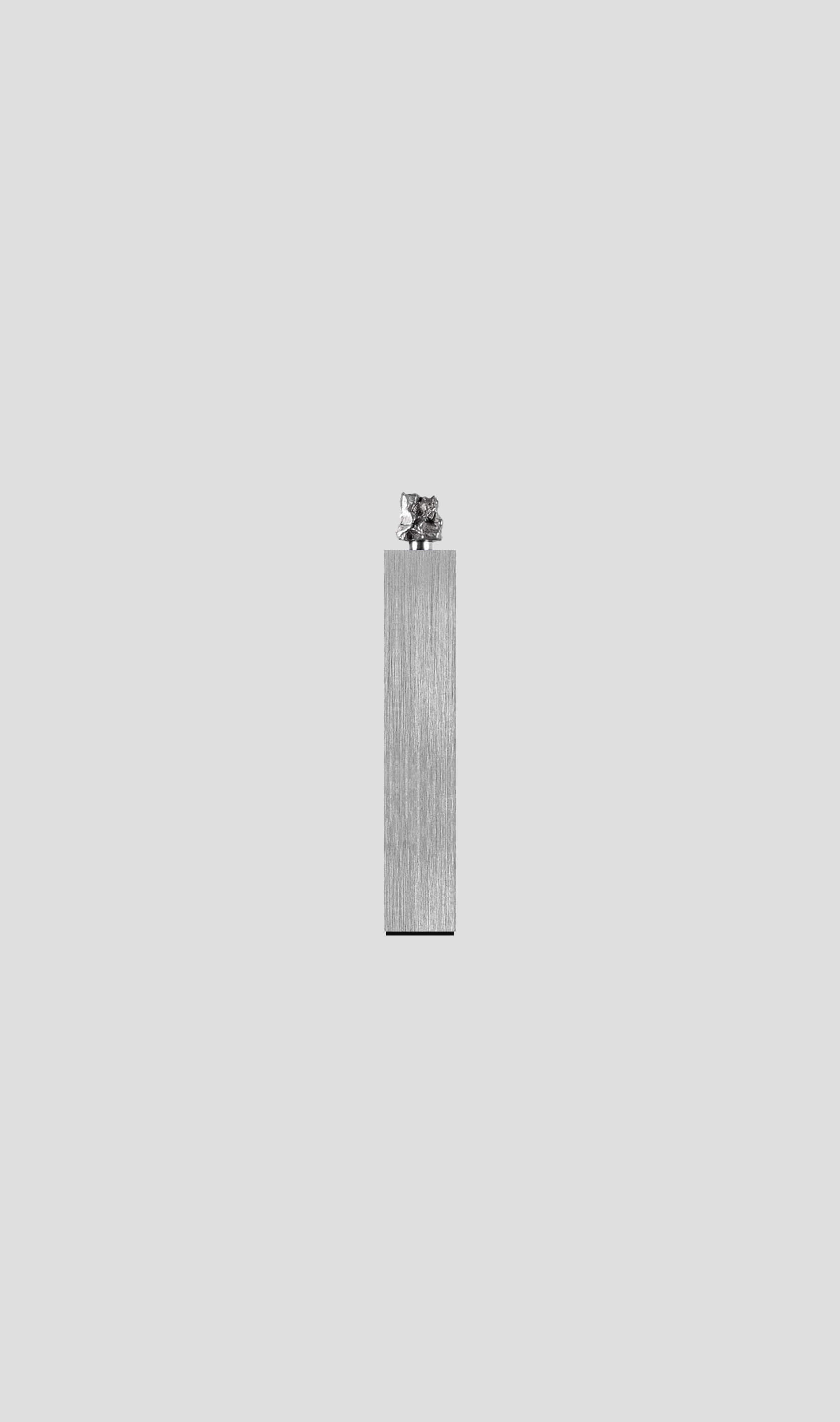 Campo Del Cielo meteorite fragment on brushed aluminum base, showcasing timeless cosmic elegance.