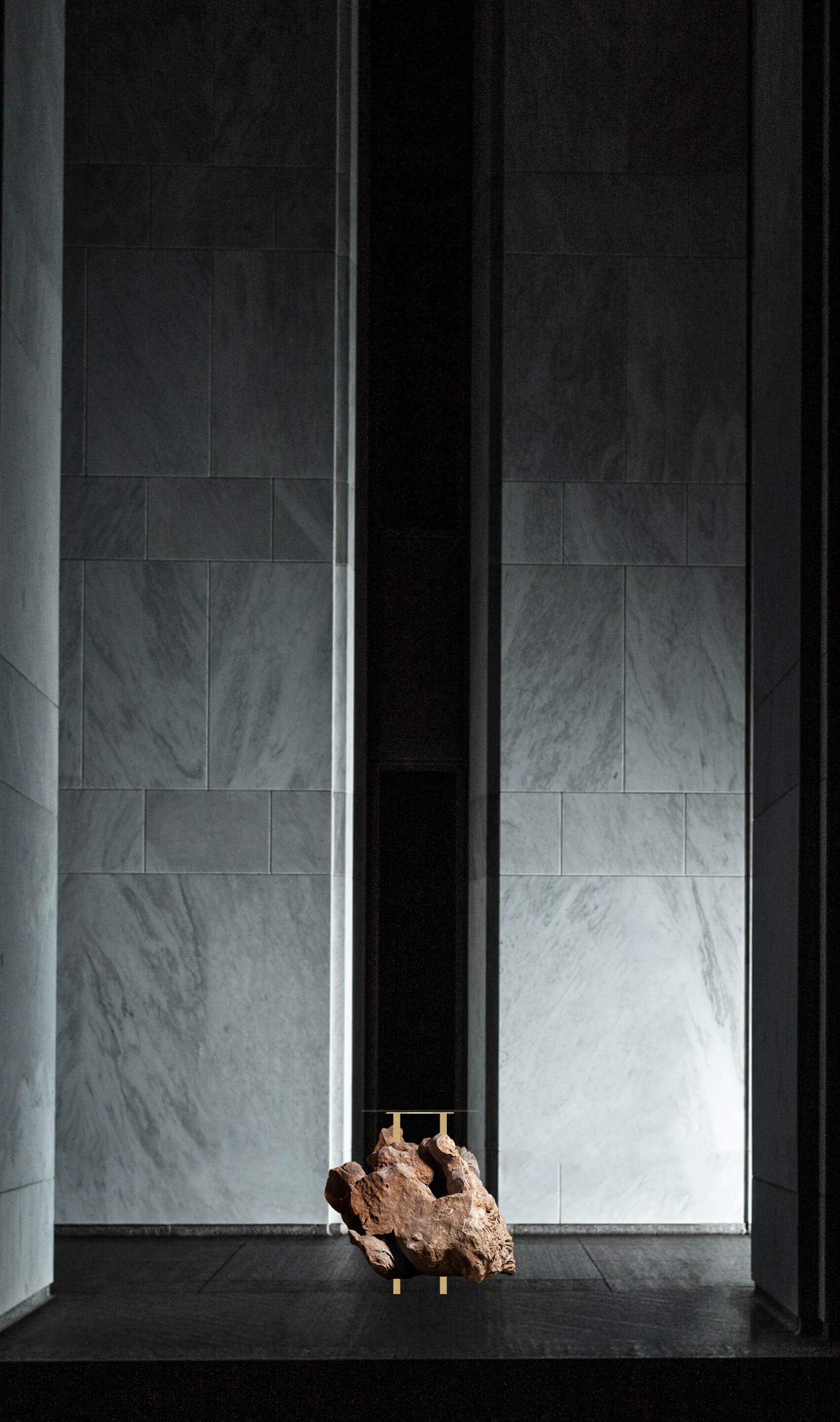 Desert Rosette Crystal formation showcased on a sleek gold aluminium table in a modern architectural setting.
