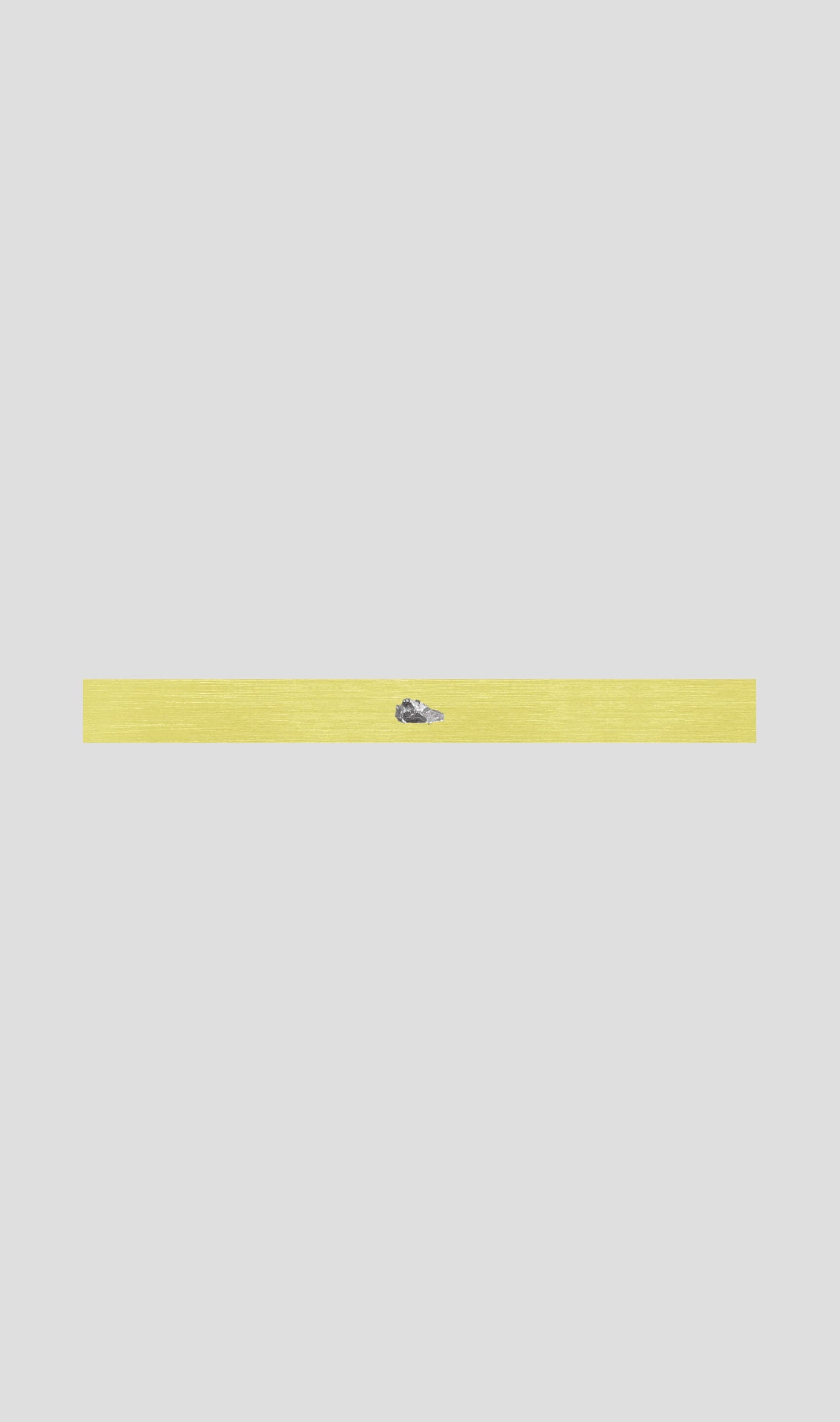 Yellow bracelet with a small blue gemstone accent, perfect for casual or elegant outfits.