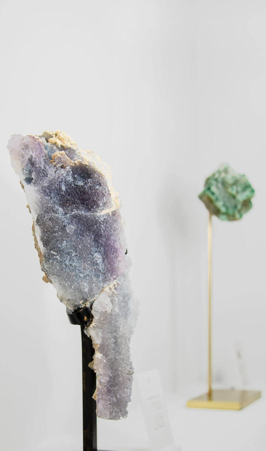 Shell amethyst presented on a lxury bronze stand contrasting the soft purple hues of the fine amethyst clusters within 2