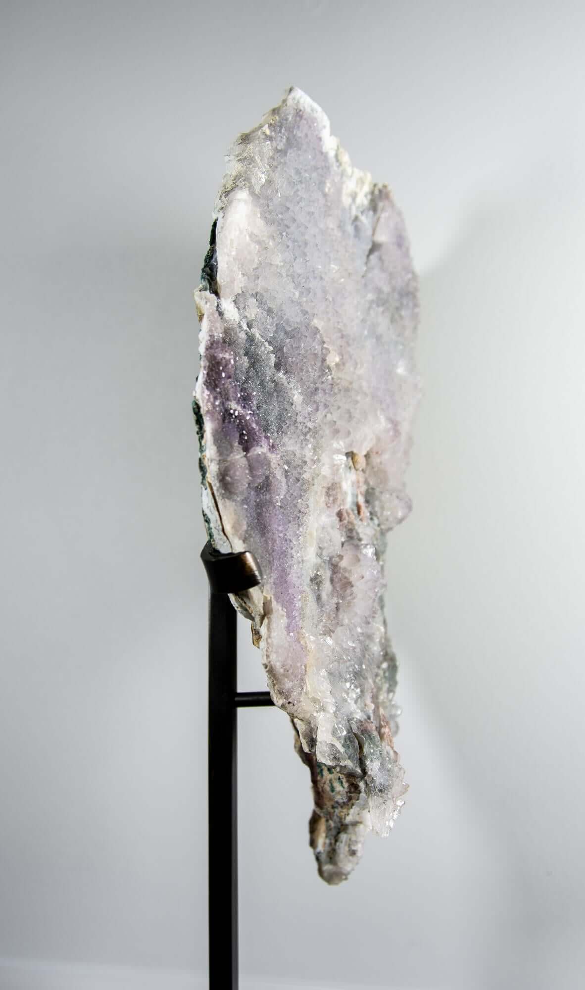 Shell amethyst presented on a lxury bronze stand contrasting the soft purple hues of the fine amethyst clusters within 13