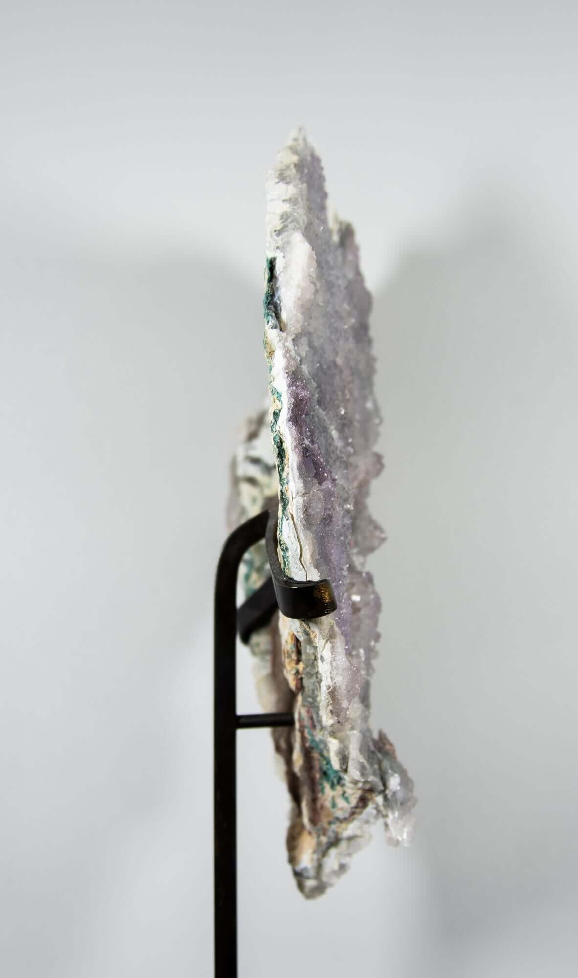 Shell amethyst presented on a lxury bronze stand contrasting the soft purple hues of the fine amethyst clusters within 14
