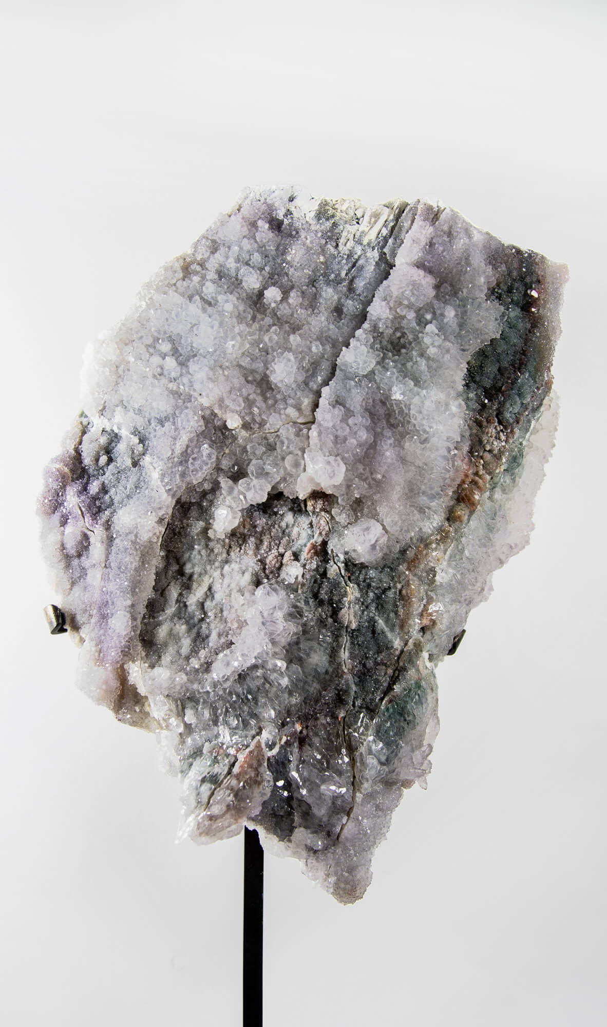 Shell amethyst presented on a lxury bronze stand contrasting the soft purple hues of the fine amethyst clusters within 15