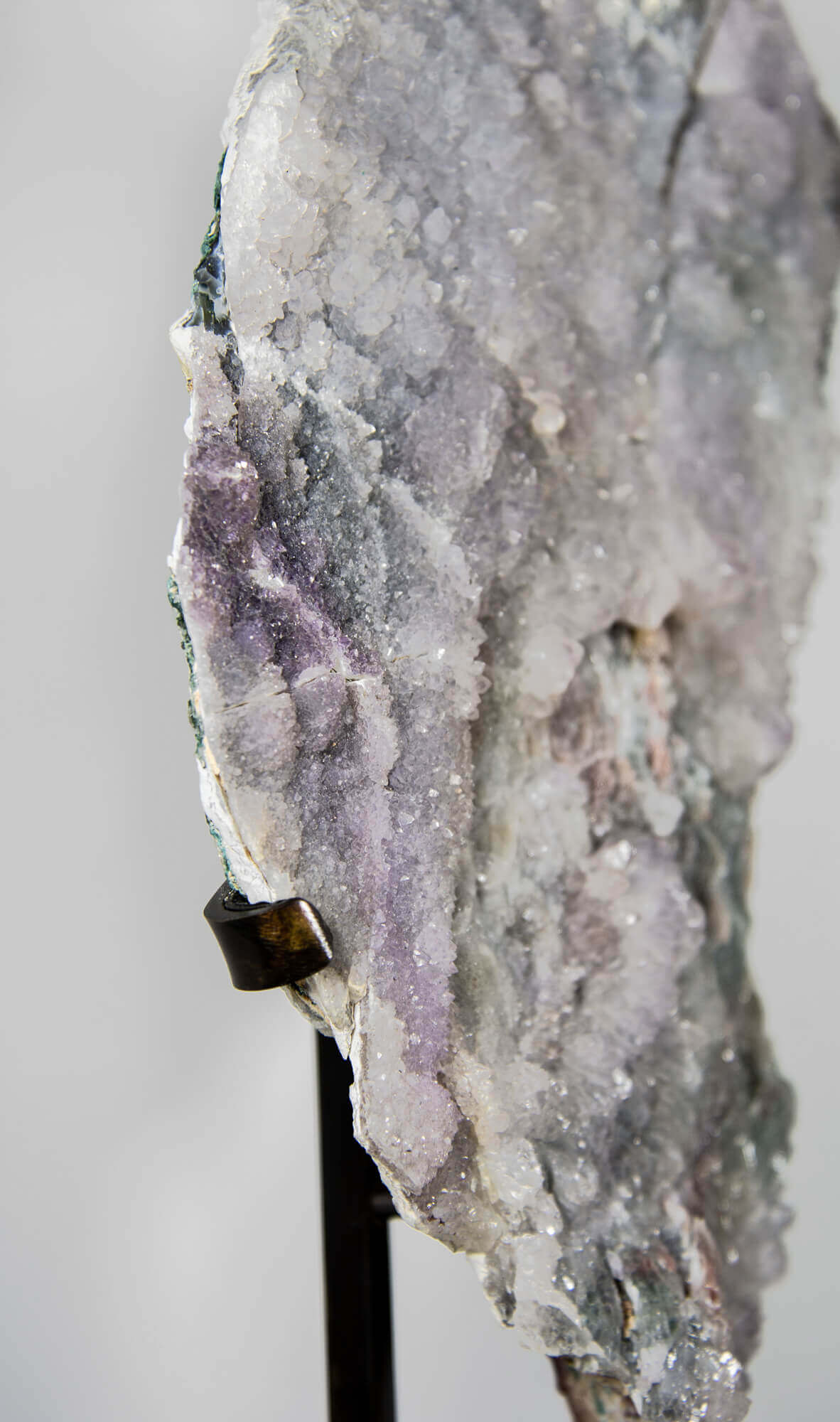 Shell amethyst presented on a lxury bronze stand contrasting the soft purple hues of the fine amethyst clusters within 17