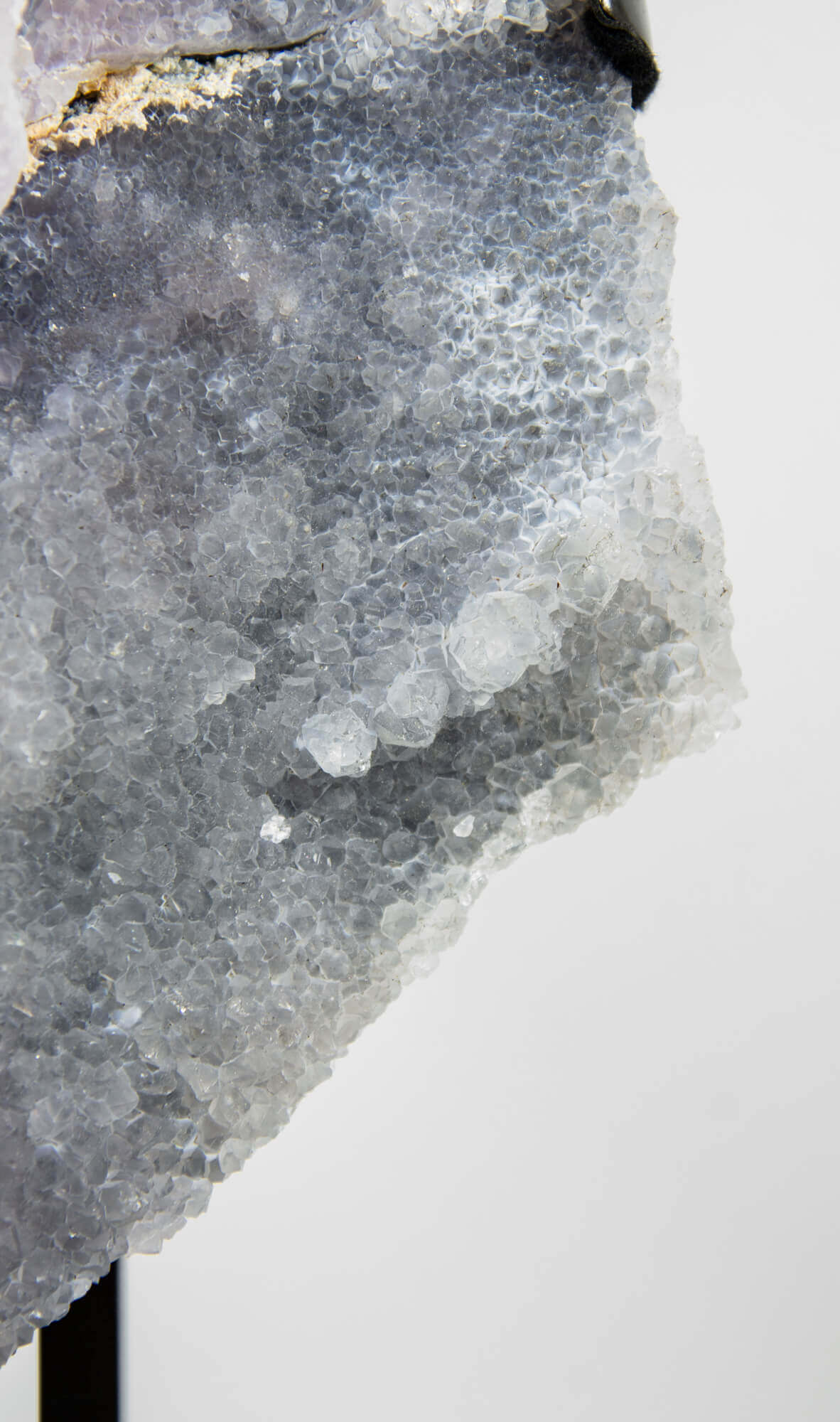 Shell amethyst presented on a lxury bronze stand contrasting the soft purple hues of the fine amethyst clusters within 9