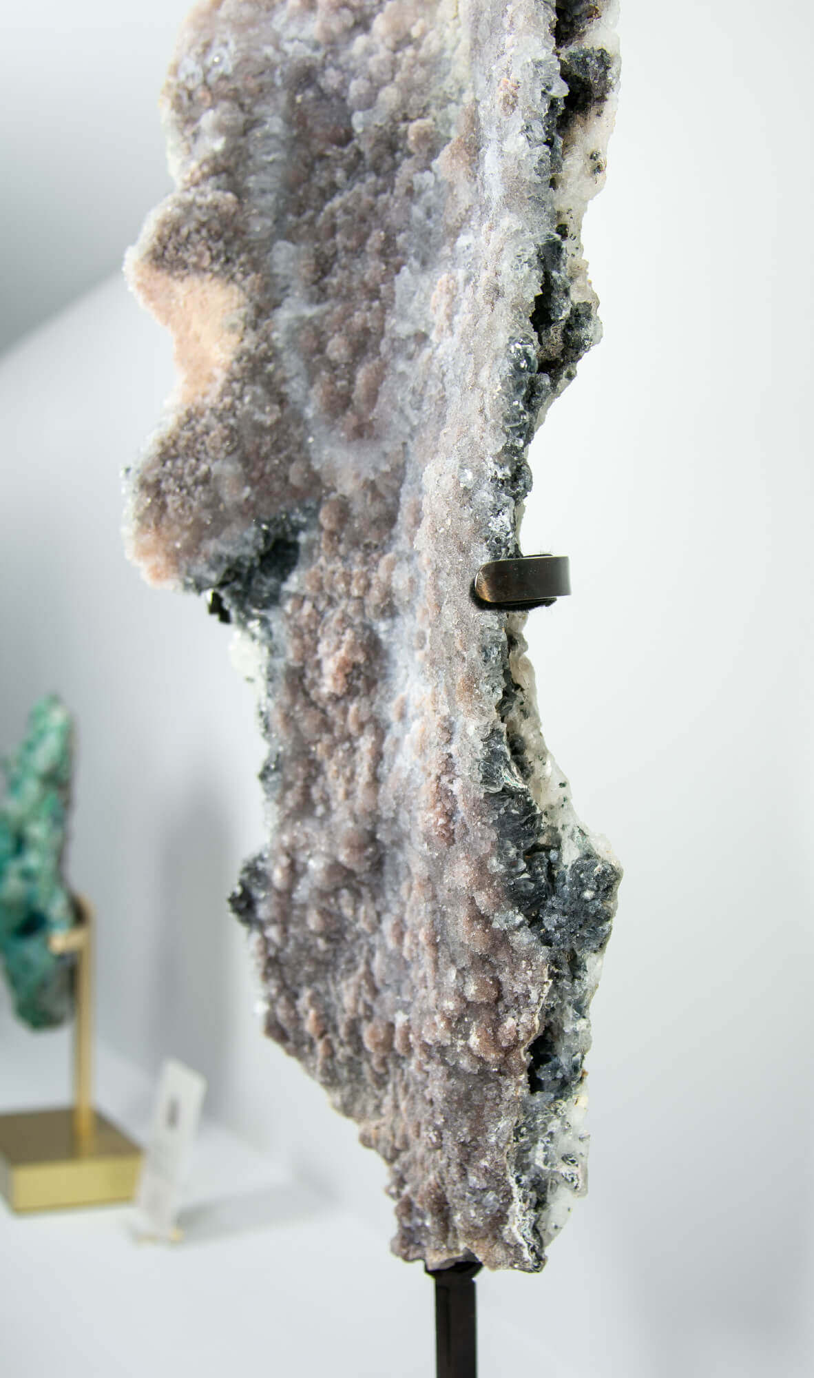 Shell amethyst presented on a lxury bronze stand contrasting the soft purple hues of the fine amethyst clusters within 23