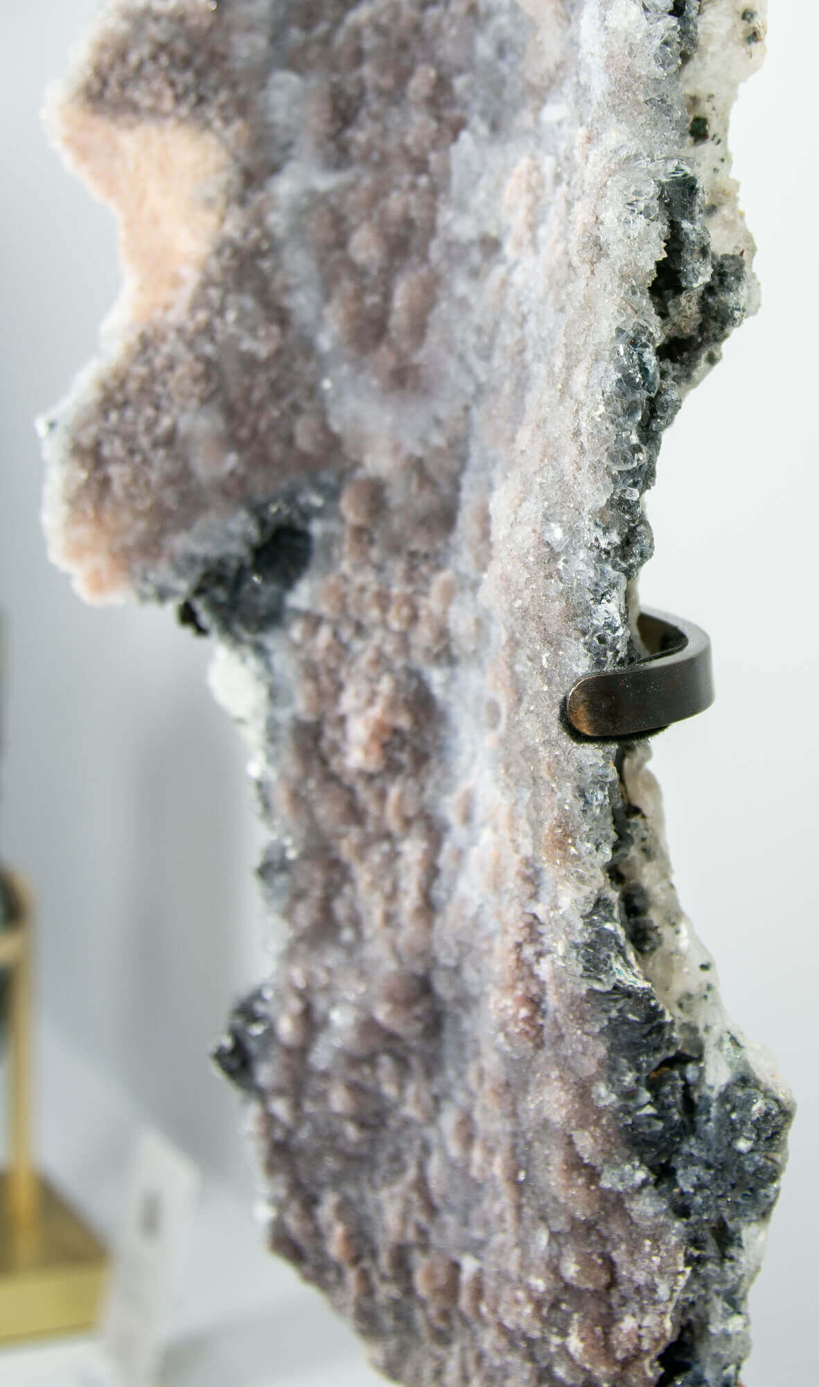 Shell amethyst presented on a lxury bronze stand contrasting the soft purple hues of the fine amethyst clusters within 26