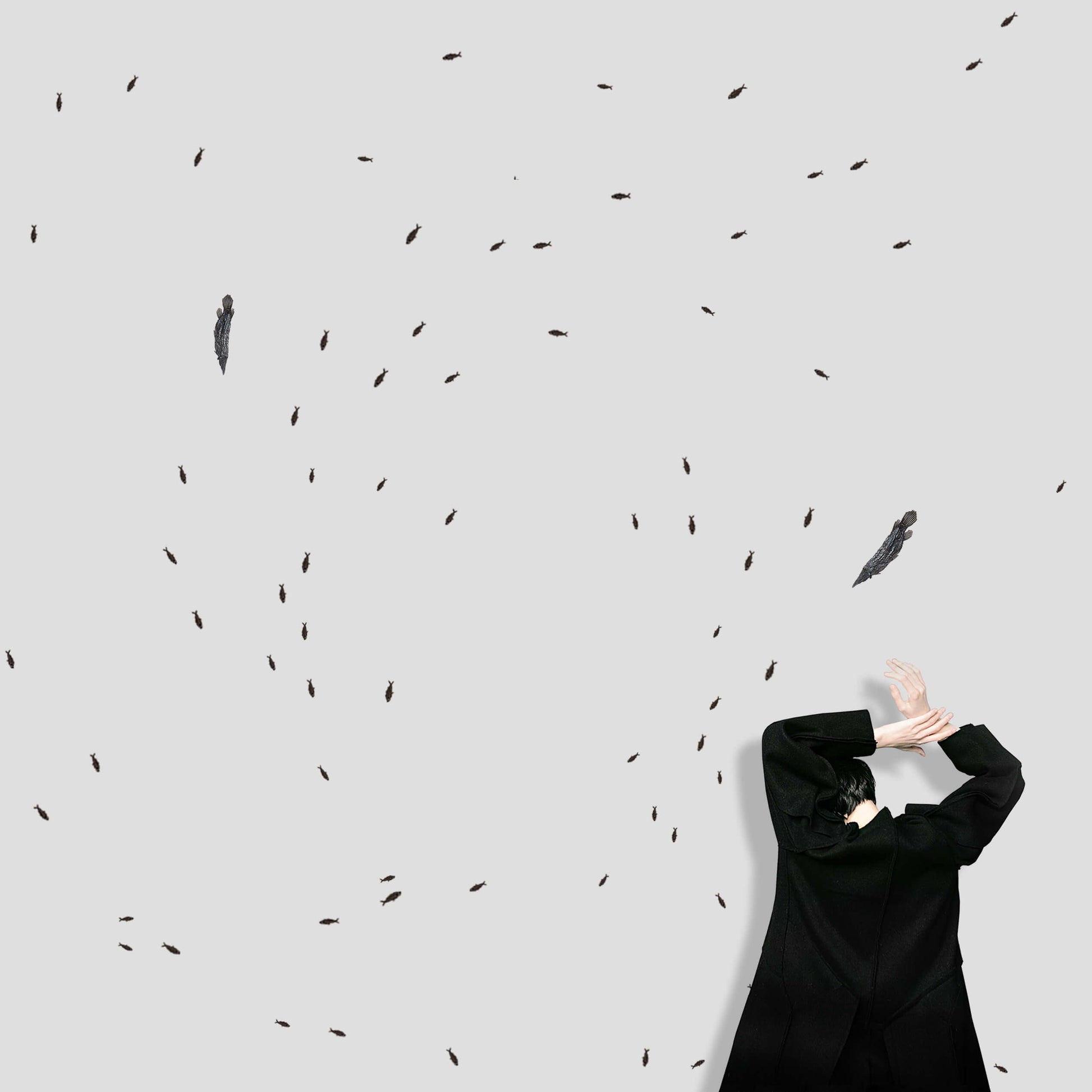 A figure in a black coat surrounded by scattered flying creatures against a light gray background.