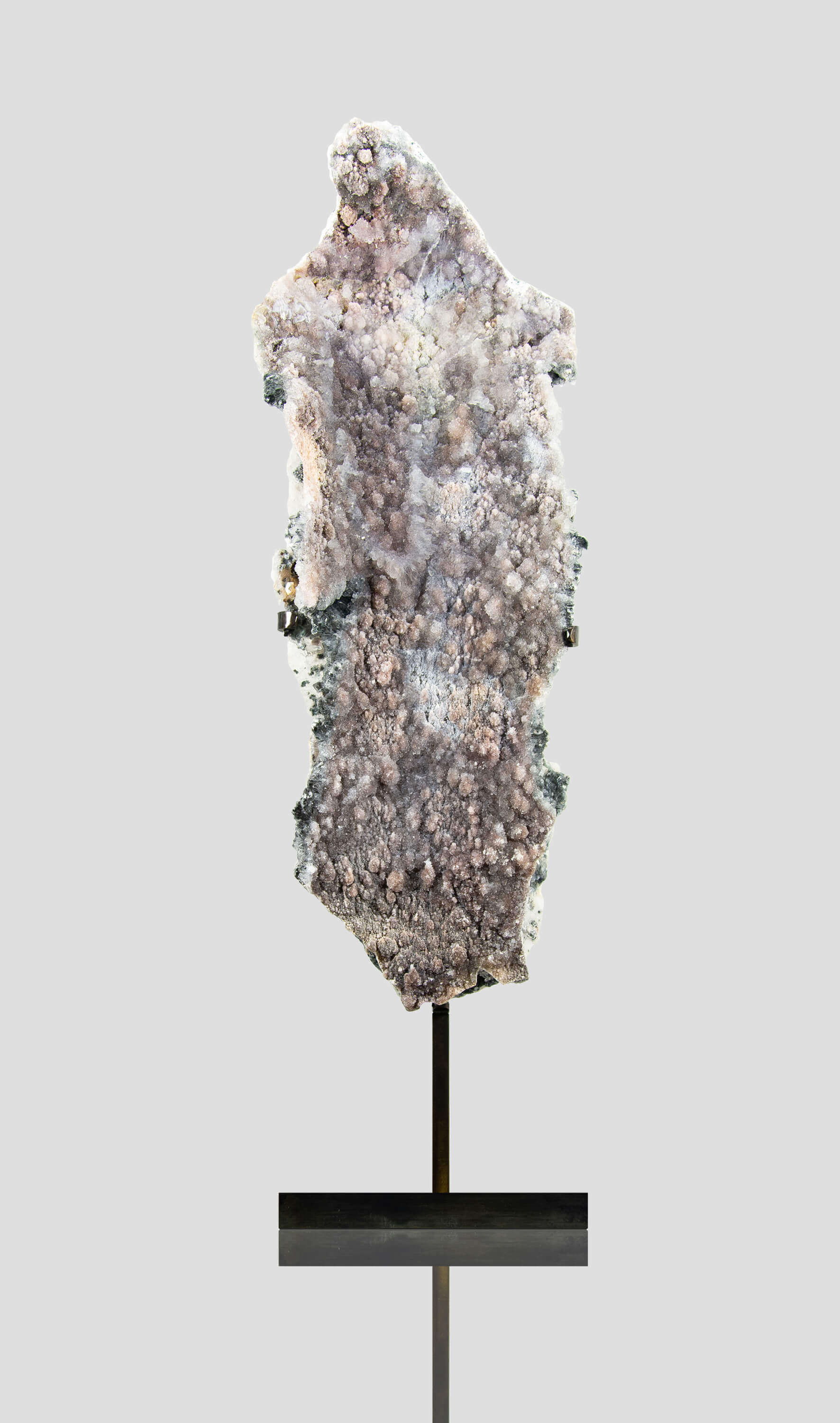 Shell amethyst presented on a lxury bronze stand contrasting the soft purple hues of the fine amethyst clusters within 21