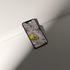 Stylish phone displaying VOSSO® digital amethyst crystal wallpaper on a minimalist surface.